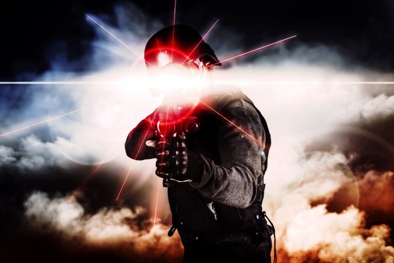 Soldier aiming assault rifle laser sight